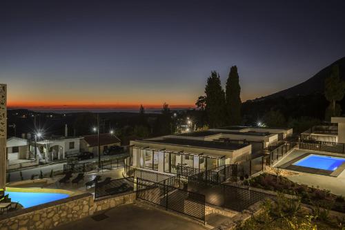 an aerial view of a house with a swimming pool at Erolidae Villas in Atsoupádhes