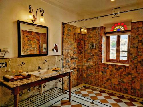 a bathroom with a sink and a mirror at Amet Haveli - A Heritage Hotel Udaipur in Udaipur