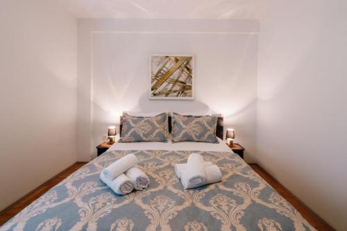 a bedroom with a bed with towels on it at Irish House Međugorje in Međugorje