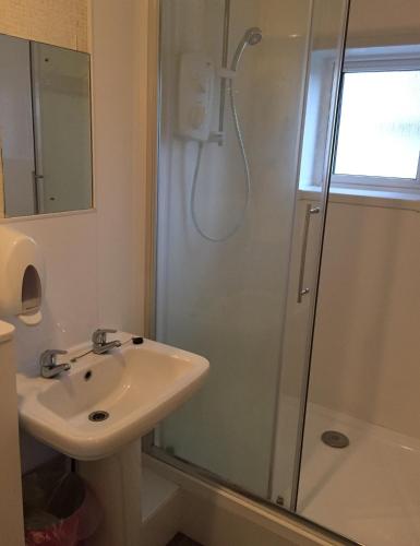 a bathroom with a sink and a shower at YHA Isle of Wight Totland - Partner in Totland