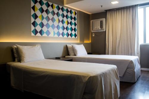 Ένα ή περισσότερα κρεβάτια σε δωμάτιο στο Master Express Cidade Baixa - Próximo à UFRGS e à Santa Casa