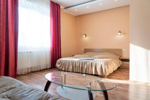 a bedroom with a bed and a glass table at Zakarpatskiy Oazis in Karpaty