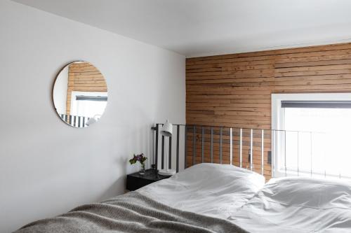 a bedroom with a white bed and a mirror at Upperud 9:9 in Åsensbruk