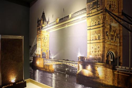a mural of the tower of london at night at Eurotraveller Hotel - Premier - Tower Bridge in London