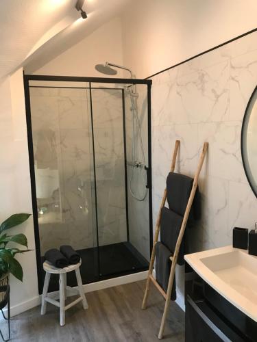 a shower with a glass door in a bathroom at Cherbourg Sea Sand in Cherbourg en Cotentin