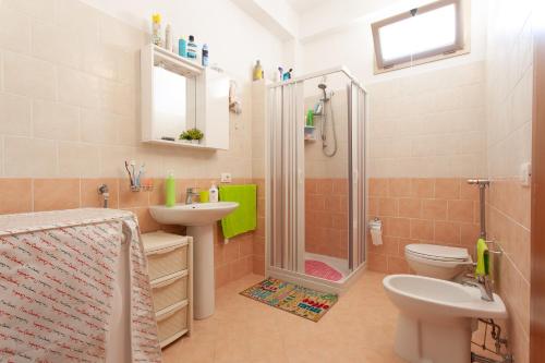 a bathroom with a shower and a toilet and a sink at Casa Gavi in Tre Fontane