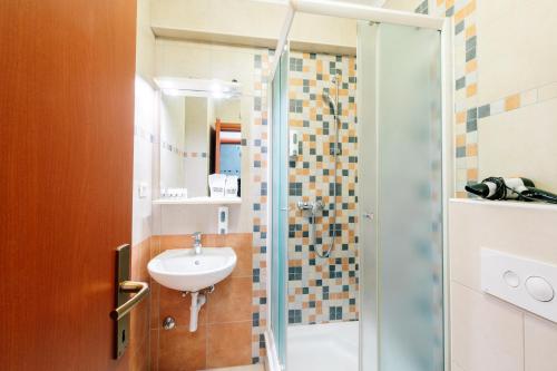 a bathroom with a sink and a shower at Irish House Međugorje in Međugorje