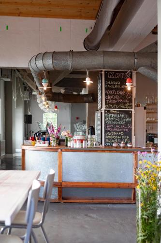 a restaurant with a bar with a chalkboard on the wall at Upperud 9:9 in Åsensbruk