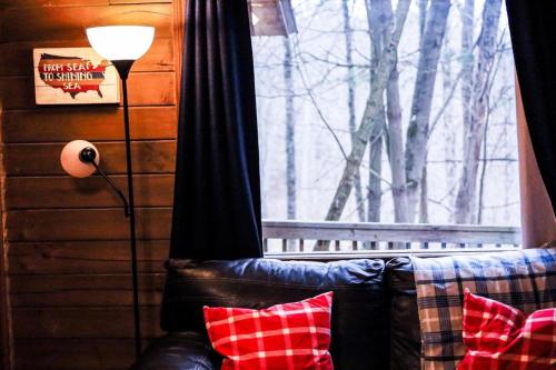 a living room with a couch and a window at Avenwood Cabins in Logan