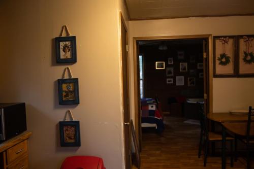 a room with a hallway with a table and pictures on the wall at Avenwood Cabins in Logan