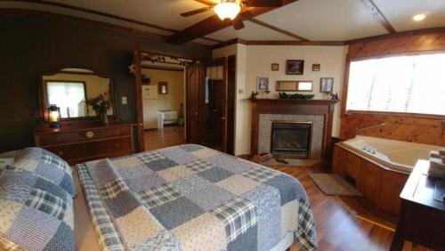 a bedroom with a bed and a bath tub at Avenwood Cabins in Logan
