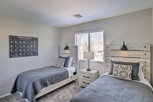 a bedroom with two beds and a window at Spacious Queen Creek Home with Pool and Game Room! in Queen Creek