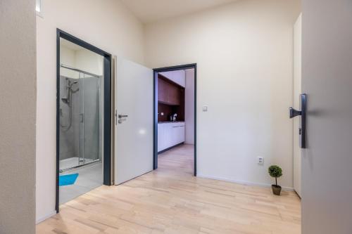 a hallway with two doors leading to a bathroom at Design apartments Brno-center in Brno