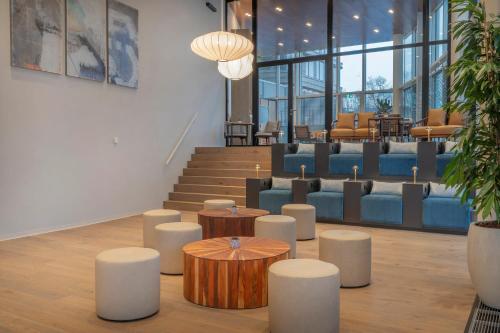 a lobby with couches and tables and chairs at INNSiDE by Meliá Amsterdam in Amsterdam