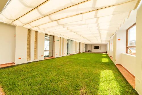 an empty hallway with green grass in a building at Biohotel Organic Suites in Bogotá