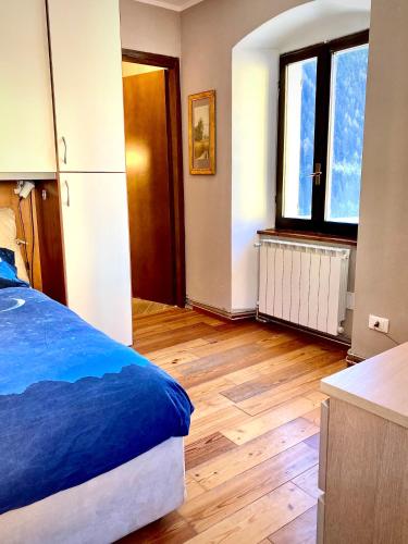 a bedroom with a bed and a wooden floor at Casa Paradiso in Vione