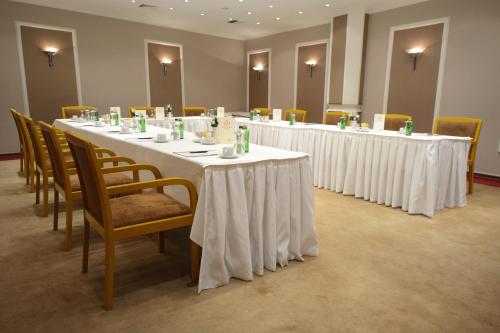 a row of tables in a room with chairs at Akgun Istanbul Hotel in Istanbul