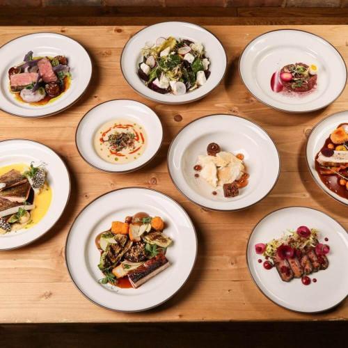 a group of plates of food on a wooden table at Pension Angusfarm in Soběsuky