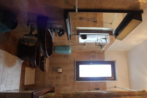 a room with a television and a wall with pots and pans at Summer house in Novalja in Novalja