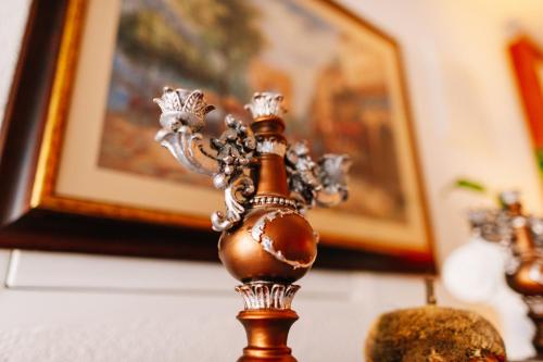 a close up of a gold candlesticks on a table at Irish House Međugorje in Međugorje