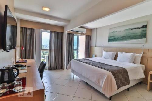 a hotel room with a bed and a desk at O Melhor do Rio de Janeiro por Carpediem in Rio de Janeiro