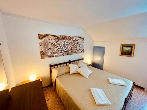 a bedroom with a large bed with two plates on it at Blue Sky apartment - Levanto, 5 Terre in Levanto