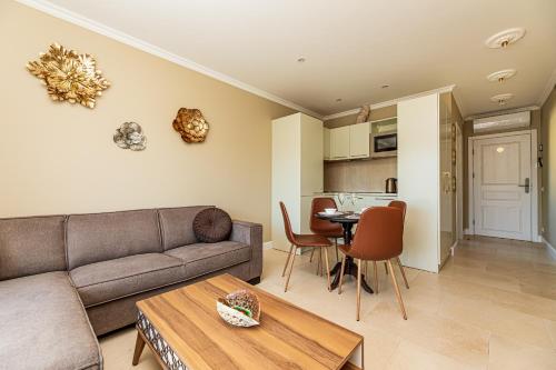 a living room with a couch and a table at Sakura_INN Palanga in Palanga