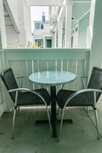 a glass table and chairs on a balcony at Pacific Blue Inn in Santa Cruz