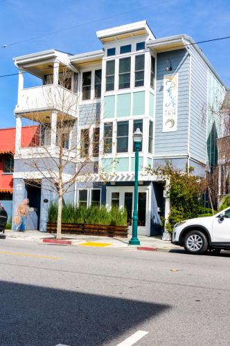 a white car parked in front of a building at Pacific Blue Inn in Santa Cruz