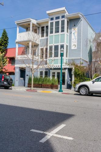a white car parked in front of a building at Pacific Blue Inn in Santa Cruz