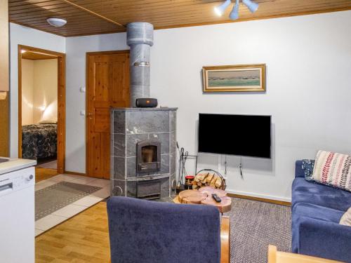 a living room with a fireplace and a tv at Holiday Home Alppitalo sinitähti 9 apt 2 by Interhome in Tahkovuori