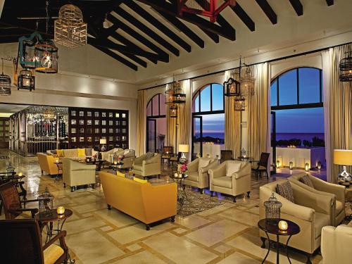 a hotel lobby with couches and tables and windows at Secrets Puerto Los Cabos Golf & Spa18+ in San José del Cabo