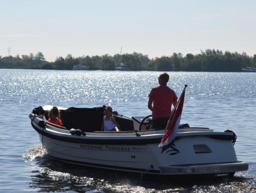 a group of people in a boat on the water at Schippershuis Terherne in Terherne