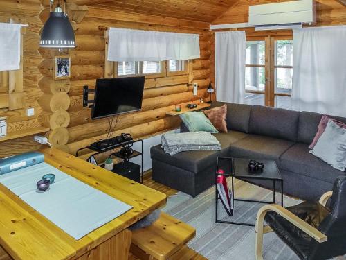 a living room with a couch and a tv at Holiday Home Lomaväinö 13 by Interhome in Salla