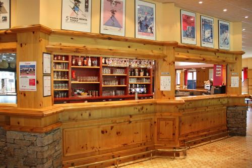 a bar in a restaurant with a wooden wall at Azureva Areches in Arêches