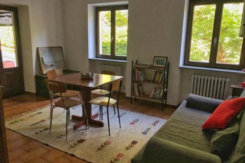 a living room with a table and a couch at TRADITIONAL VILLA BELLAGIO san primo LAKE COMO in Bellagio