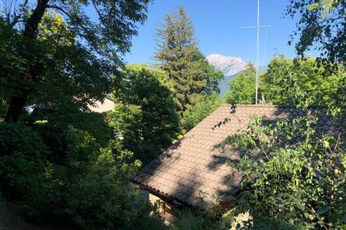 a roof of a house with trees and a mountain at TRADITIONAL VILLA BELLAGIO san primo LAKE COMO in Bellagio