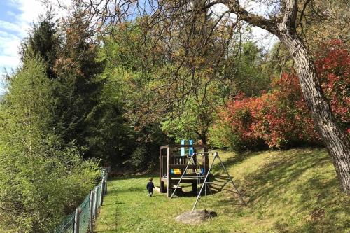 a child standing in the grass next to a playground at TRADITIONAL VILLA BELLAGIO san primo LAKE COMO in Bellagio