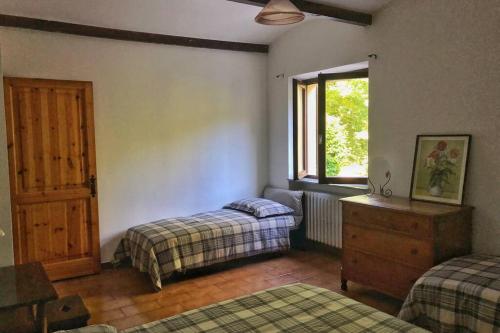 a bedroom with two beds and a window at TRADITIONAL VILLA BELLAGIO san primo LAKE COMO in Bellagio