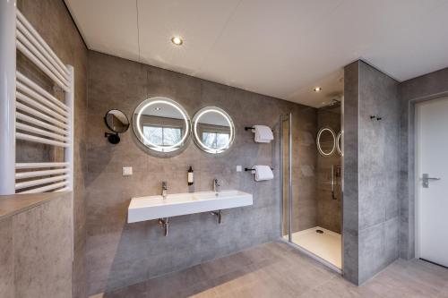 a bathroom with a sink and a shower at Broeck Oudewater in Oudewater