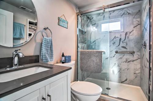 a bathroom with a shower and a toilet and a sink at Walk to Shore: Updated Buzzards Bay Cottage! in Buzzards Bay