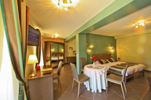 a hotel room with a bed and a table and chairs at Hotel Restaurant Laborderie in Tamniès
