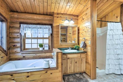 a wooden bathroom with a tub and a sink and a tub at Piedmont Cabin about 10 Mi to Rapid City! in Piedmont