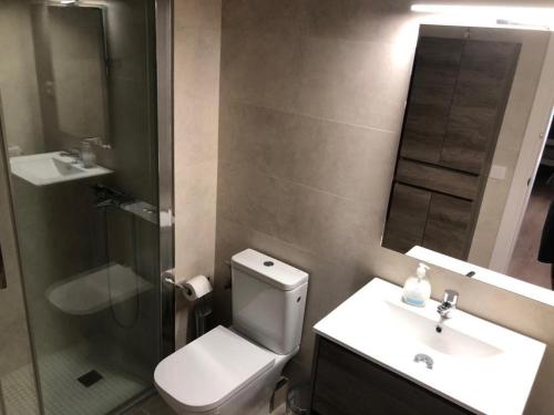 a bathroom with a toilet and a sink and a shower at BLANES APARTAMENTO in Blanes