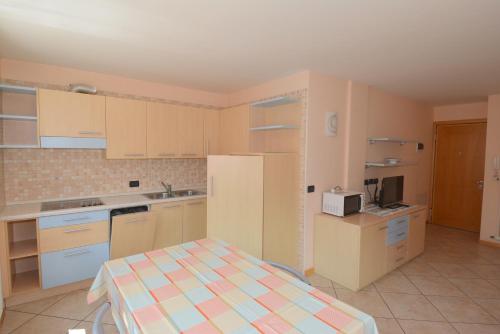 a kitchen with white cabinets and a counter top at Casa Fior del Soreie in Pozza di Fassa