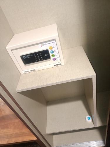 a white shelf with a scale on top of it at Clarks Inn Express, Jammu in Jammu