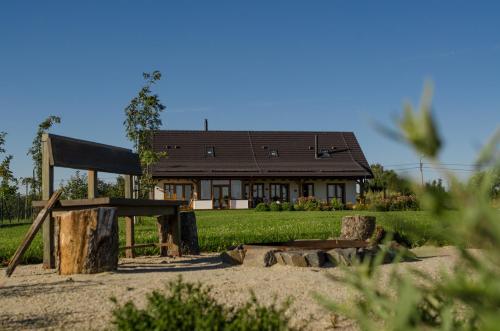 a house with a playground in front of it at Penzion V Poli in Klimkovice