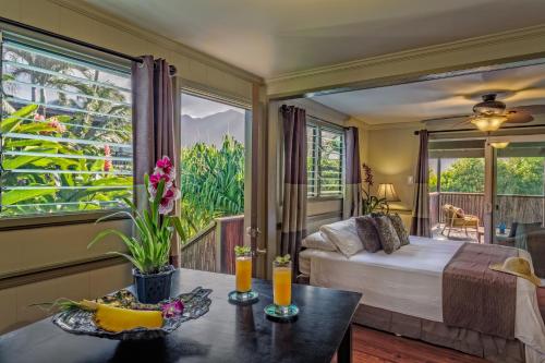 a bedroom with a bed and a large window at Paradise Bay Resort in Kaneohe