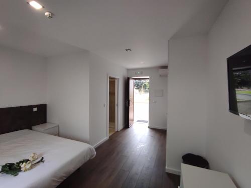 a bedroom with a bed with flowers on it at Quinta do Gestal - Soutelo in Vila Verde