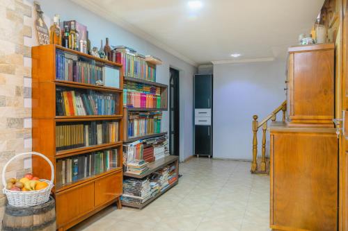 a room with book shelves filled with books at Khvamli 2002 in Tsʼageri